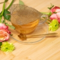 Gold Strainer and teaspoon set with glass cup and flowers