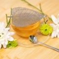 Silver strainer and flower teaspoon set with a glass cup